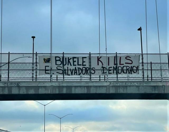 Banner hangs in El Salvador with text: "Bukele kills El Salvador's democracy."