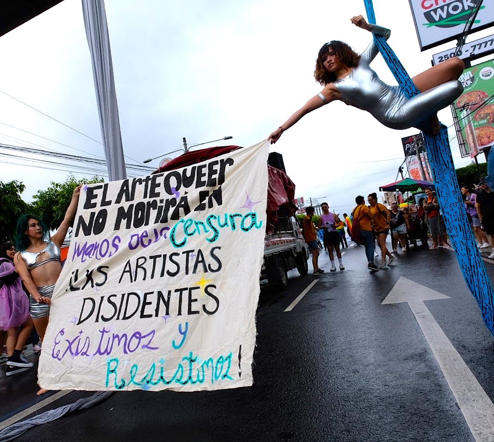 Protesters holding a banner that says "Queer art will not die at the hands of censorship. Dissident artists exist and resist!"