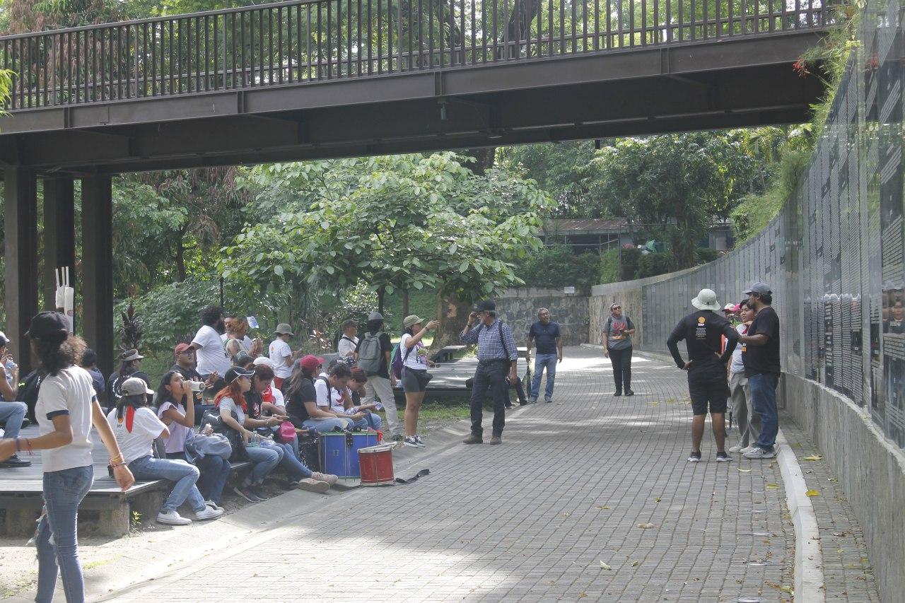 Marchers gather in front of the Monument to Memory and Truth