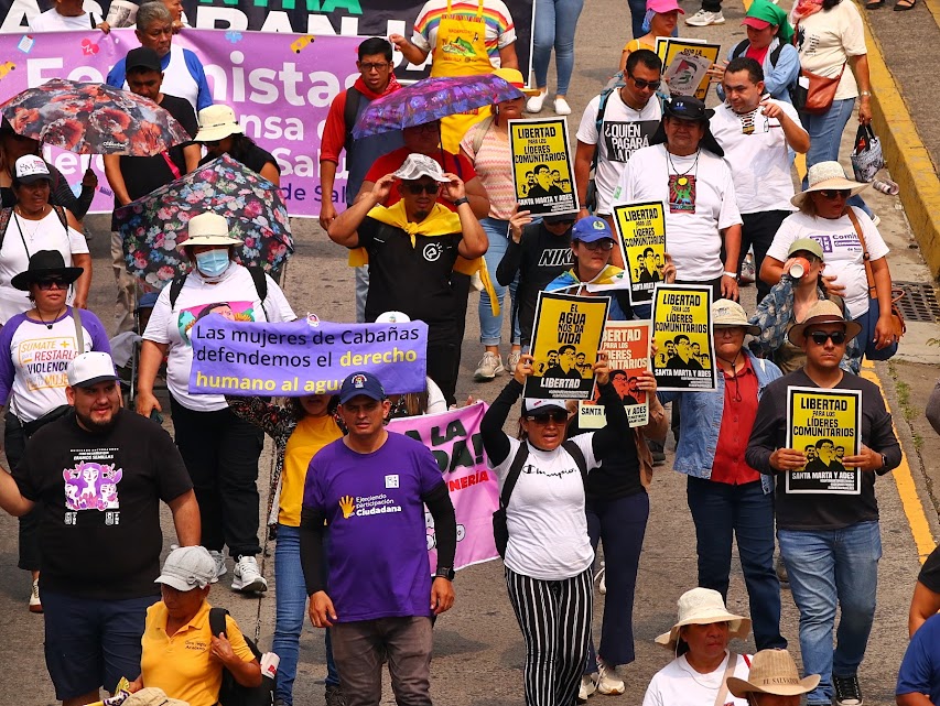 May Day marchers with yellow signs supporting Santa Marta environmentalists.