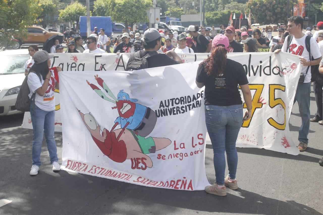 Protesters hold a banner with Spongebob Squarepants characters caling for university autonomy