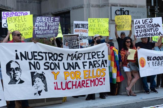 Photo of demonstrators holding signs and banners in front of the Salvadoran Embassy on June 1