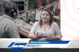 Woman sitting at a desk with a graphic of her name, Monica Rodriguez, below her