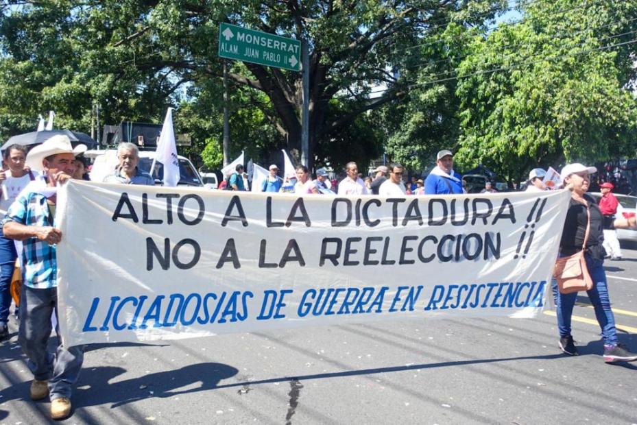Protesters hold a banner that reads "STOP THE DICTATORSHIP! No Reelection!" 