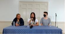 Representatives from Socorro Juridico Humanitario and CISPES sit at a table during a press conference